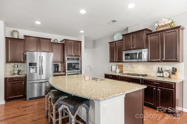 3701 Methodist Church Ln, Waxhaw, NC 28173 - kitchen with stainless steel appliances, backsplash, dark brown cabinetry, light wood finished floors, and recessed lighting