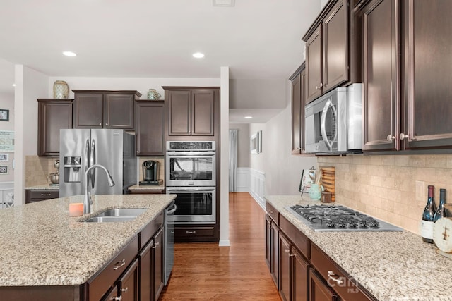 3701 Methodist Church Ln, Waxhaw, NC 28173 - kitchen featuring stainless steel appliances, wood finished floors, dark brown cabinetry, light stone countertops, and recessed lighting