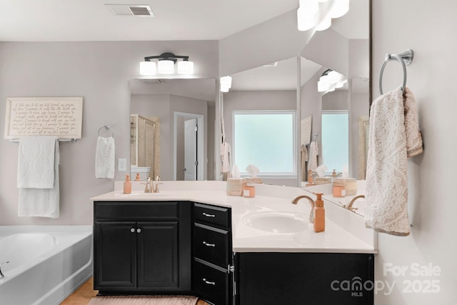 3701 Methodist Church Ln, Waxhaw, NC 28173 - full bathroom with double vanity, a stall shower, and a garden tub