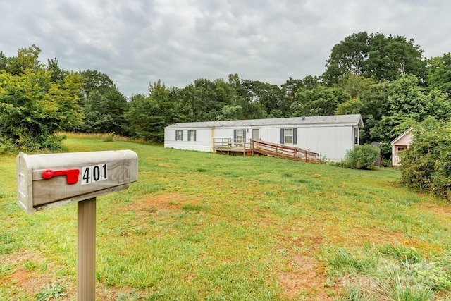 401 Webb Church Rd, Ellenboro, NC 28040 - manufactured / mobile home featuring a front lawn, a deck, and a view of trees