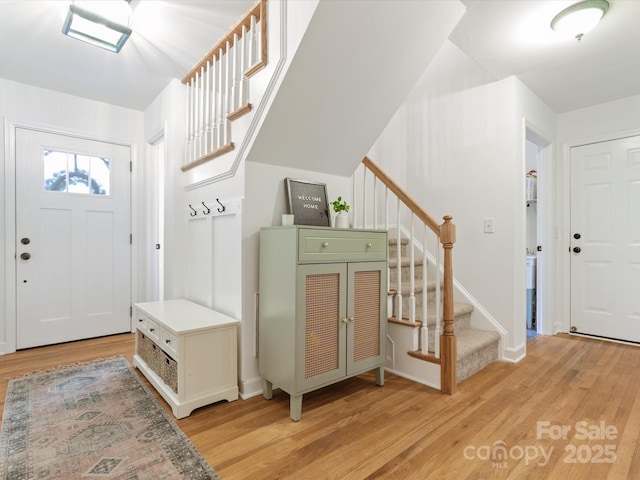 6934 Loretta Pl, Charlotte, NC 28215 - foyer entrance with stairway and light wood-style flooring