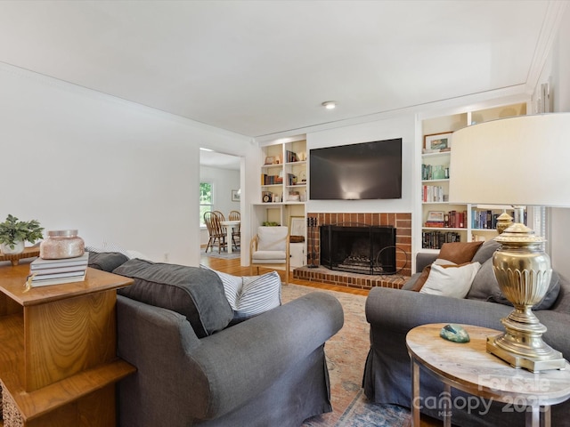 6934 Loretta Pl, Charlotte, NC 28215 - living room featuring a brick fireplace and wood finished floors