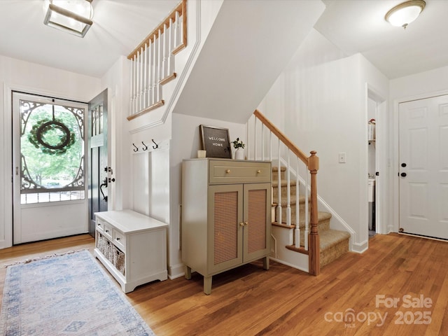 6934 Loretta Pl, Charlotte, NC 28215 - entryway with stairway and light wood finished floors
