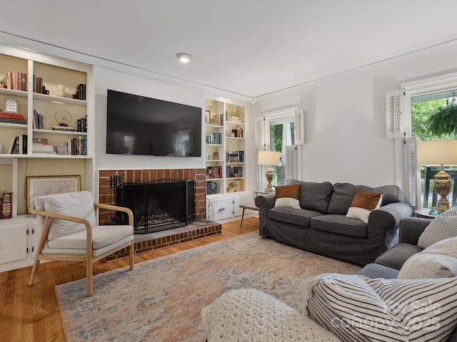 6934 Loretta Pl, Charlotte, NC 28215 - living area with wood finished floors, a brick fireplace, and built in shelves