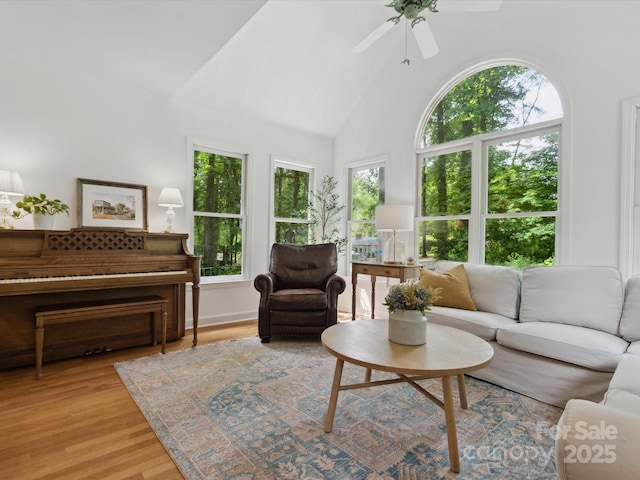 6934 Loretta Pl, Charlotte, NC 28215 - living area with ceiling fan, light wood-style floors, and high vaulted ceiling