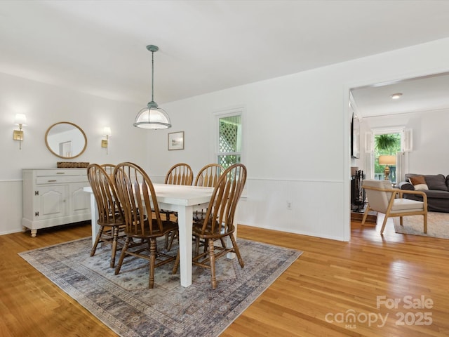 6934 Loretta Pl, Charlotte, NC 28215 - dining space with light wood finished floors, plenty of natural light, and wainscoting