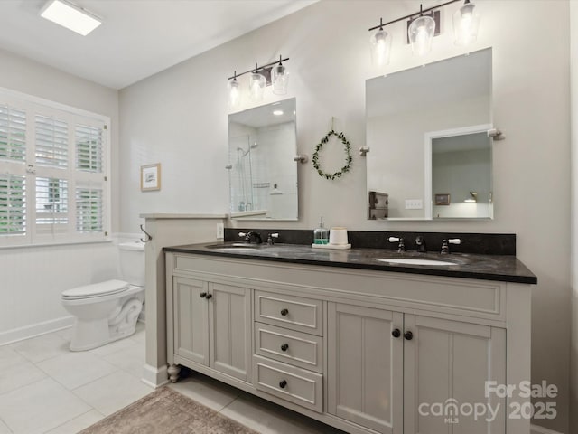 6934 Loretta Pl, Charlotte, NC 28215 - bathroom with double vanity, a shower, and tile patterned flooring