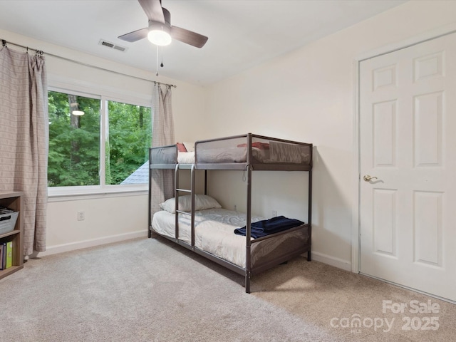 6934 Loretta Pl, Charlotte, NC 28215 - carpeted bedroom with baseboards and ceiling fan