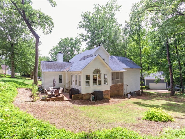 6934 Loretta Pl, Charlotte, NC 28215 - rear view of property with a yard, a chimney, an outdoor structure, and a patio area