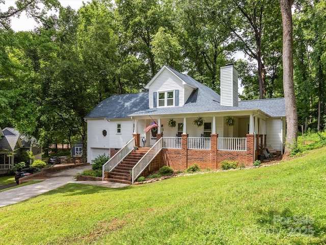 6934 Loretta Pl, Charlotte, NC 28215 - view of front of home with a porch, a chimney, a garage, and a front yard