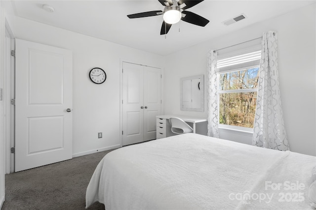 3735 Ernie Dr, Charlotte, NC 28269 - bedroom with dark colored carpet, a closet, and a ceiling fan