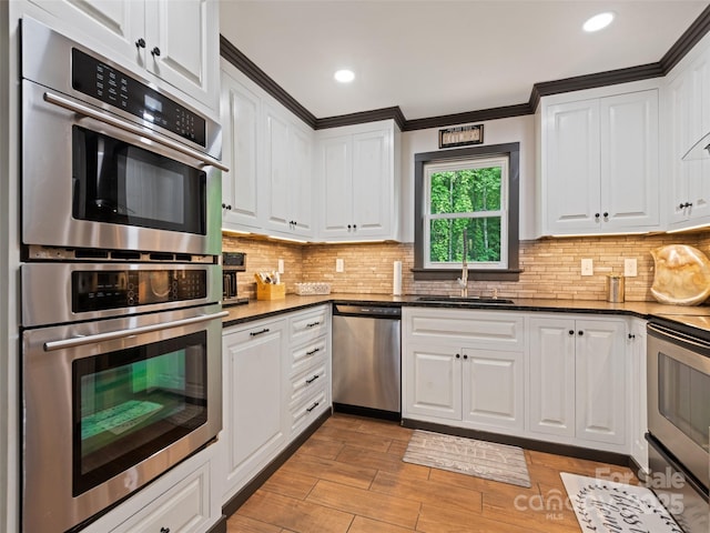 229 Yellow Bird Branch Rd, Sylva, NC 28779 - kitchen featuring appliances with stainless steel finishes, white cabinets, light wood finished floors, tasteful backsplash, and recessed lighting