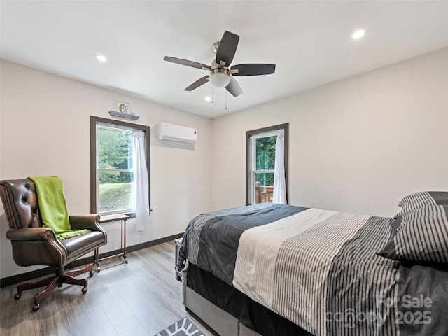 229 Yellow Bird Branch Rd, Sylva, NC 28779 - bedroom featuring wood finished floors, recessed lighting, an AC wall unit, and ceiling fan