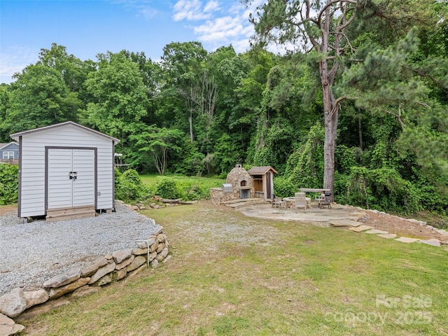 229 Yellow Bird Branch Rd, Sylva, NC 28779 - view of grassy yard featuring a storage shed, a patio, and a forest view