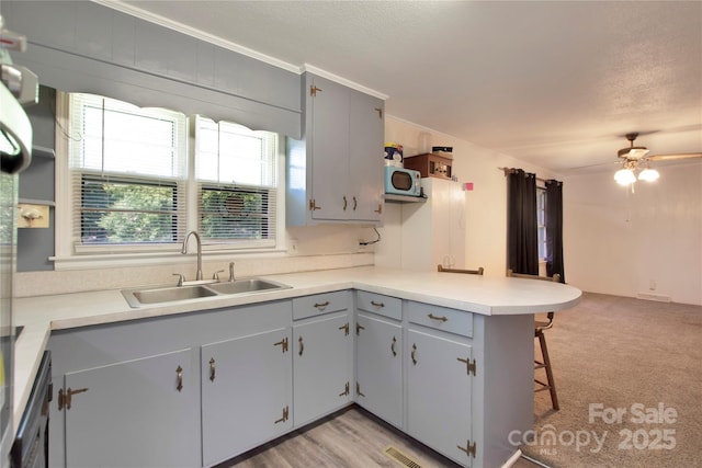 1145 Craigbrow Cir, Chester, SC 29706 - kitchen featuring a peninsula, a kitchen bar, light countertops, ceiling fan, and gray cabinets