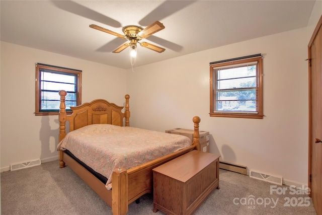 1145 Craigbrow Cir, Chester, SC 29706 - bedroom featuring a baseboard heating unit, multiple windows, light colored carpet, and ceiling fan