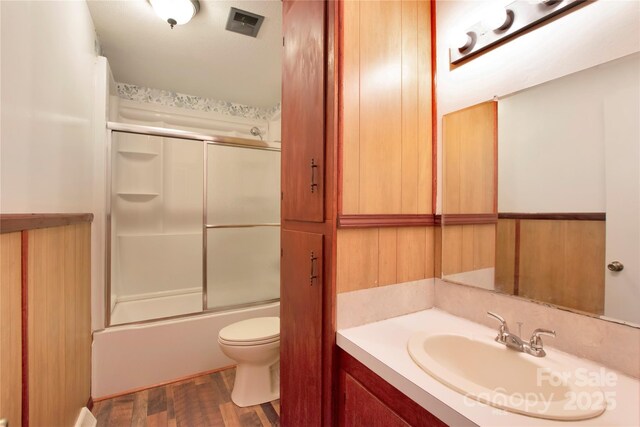 1145 Craigbrow Cir, Chester, SC 29706 - bathroom featuring vanity, wood finished floors, and bath / shower combo with glass door