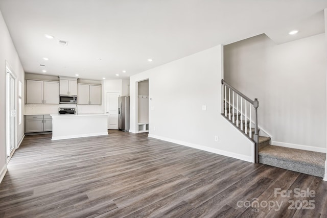 2125 Rolling Hills Ct, Stanley, NC 28164 - unfurnished living room featuring wood finished floors, stairs, and recessed lighting