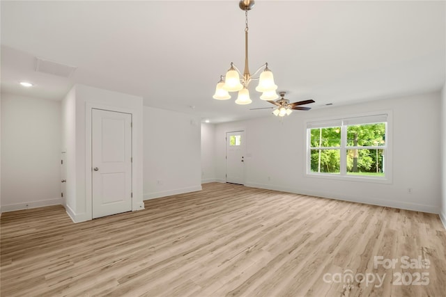 443 Faith Dr SW, Concord, NC 28027 - unfurnished room featuring light wood-style floors, a chandelier, and a ceiling fan