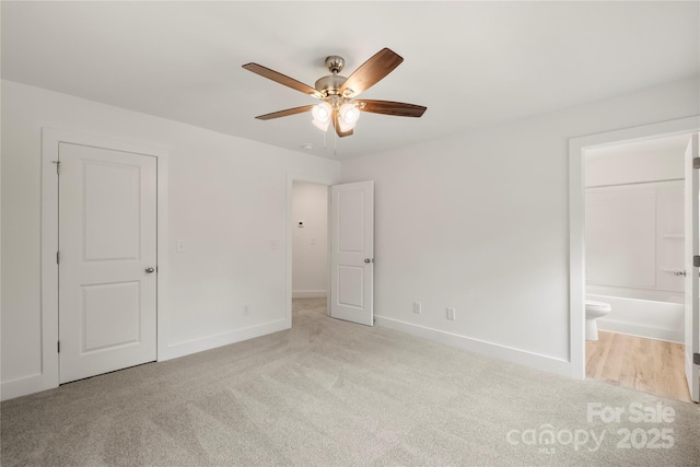 443 Faith Dr SW, Concord, NC 28027 - unfurnished bedroom featuring carpet floors, ensuite bath, and a ceiling fan