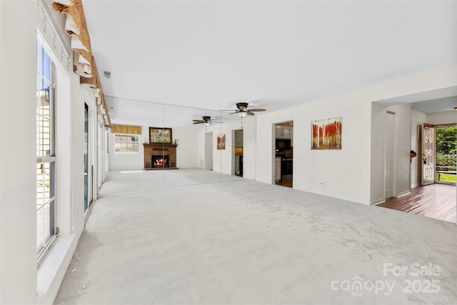 1670 Robins Nest Ct Unit D, Gastonia, NC 28054 - unfurnished living room featuring a warm lit fireplace, carpet, and ceiling fan