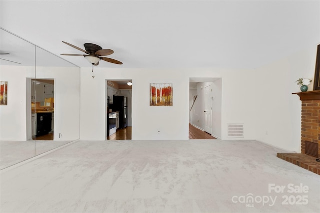1670 Robins Nest Ct Unit D, Gastonia, NC 28054 - unfurnished living room featuring a ceiling fan, carpet, and a brick fireplace