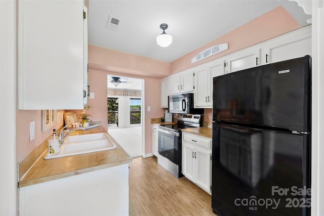 1670 Robins Nest Ct Unit D, Gastonia, NC 28054 - kitchen with black appliances, white cabinetry, a ceiling fan, light countertops, and light wood-style floors