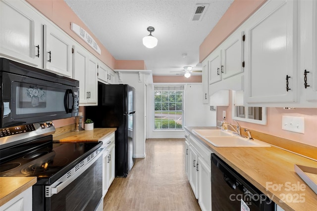 1670 Robins Nest Ct Unit D, Gastonia, NC 28054 - kitchen featuring black appliances, white cabinetry, light wood-style floors, a ceiling fan, and a textured ceiling