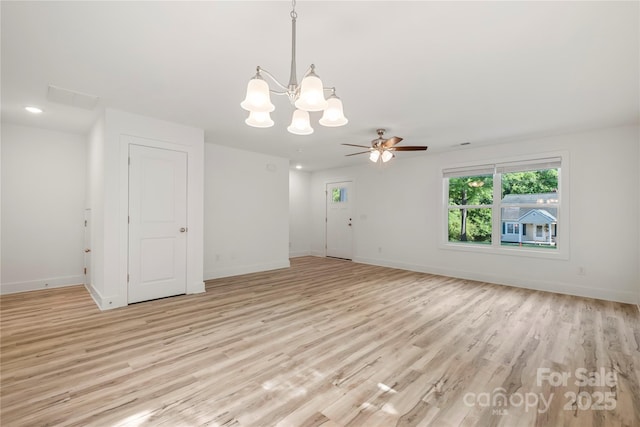 445 Faith Dr SW, Concord, NC 28027 - unfurnished room with a chandelier, light wood-style flooring, and a ceiling fan