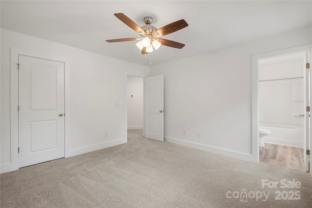 445 Faith Dr SW, Concord, NC 28027 - unfurnished bedroom with light colored carpet, ensuite bath, and ceiling fan