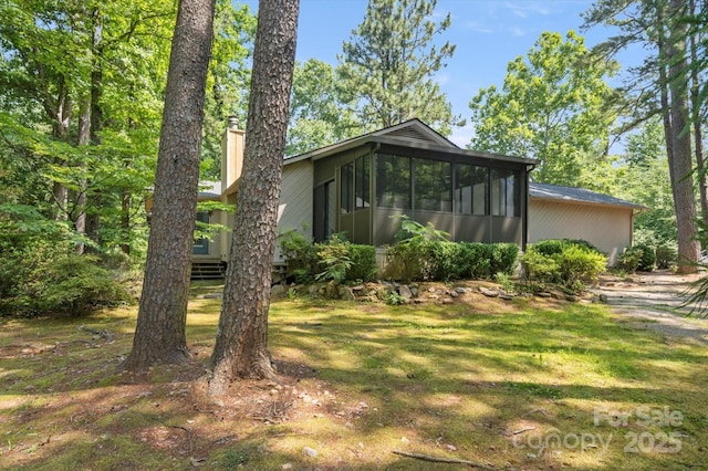 55 Diamond Ridge Ln, Columbus, NC 28722 - view of home's exterior with a sunroom and a yard
