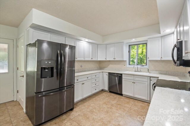 55 Diamond Ridge Ln, Columbus, NC 28722 - kitchen with stainless steel appliances, decorative backsplash, light countertops, and white cabinetry