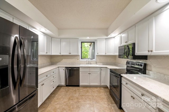 55 Diamond Ridge Ln, Columbus, NC 28722 - kitchen featuring stainless steel appliances, light countertops, white cabinets, decorative backsplash, and light tile patterned floors