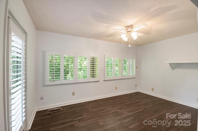 55 Diamond Ridge Ln, Columbus, NC 28722 - unfurnished room with ceiling fan, dark wood-style flooring, and a textured ceiling