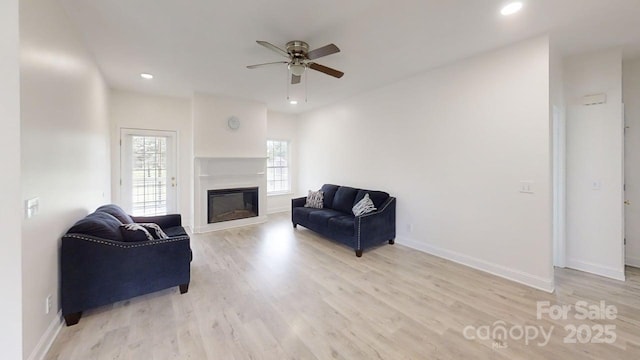 6825 Woodleaf Rd, Woodleaf, NC 27054 - living room with ceiling fan, light wood-style floors, a glass covered fireplace, and recessed lighting