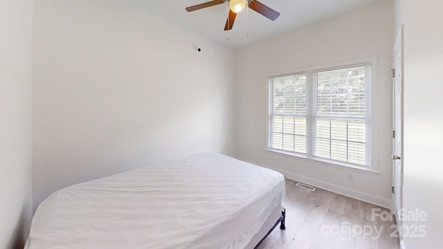 6825 Woodleaf Rd, Woodleaf, NC 27054 - bedroom with light wood-style flooring and ceiling fan