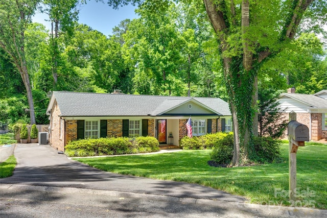 7026 Tabor Ln, Charlotte, NC 28211 - ranch-style home featuring brick siding, a front lawn, asphalt driveway, a chimney, and roof with shingles