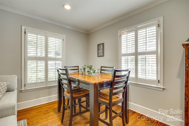 7026 Tabor Ln, Charlotte, NC 28211 - dining space featuring ornamental molding, wood finished floors, and recessed lighting