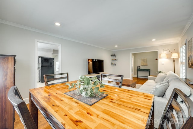 7026 Tabor Ln, Charlotte, NC 28211 - dining space featuring wood finished floors, crown molding, and recessed lighting