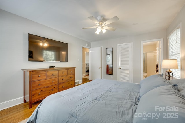 7026 Tabor Ln, Charlotte, NC 28211 - bedroom with wood finished floors, ceiling fan, and connected bathroom