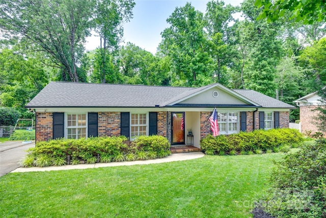 7026 Tabor Ln, Charlotte, NC 28211 - ranch-style home featuring brick siding, a front lawn, and a shingled roof
