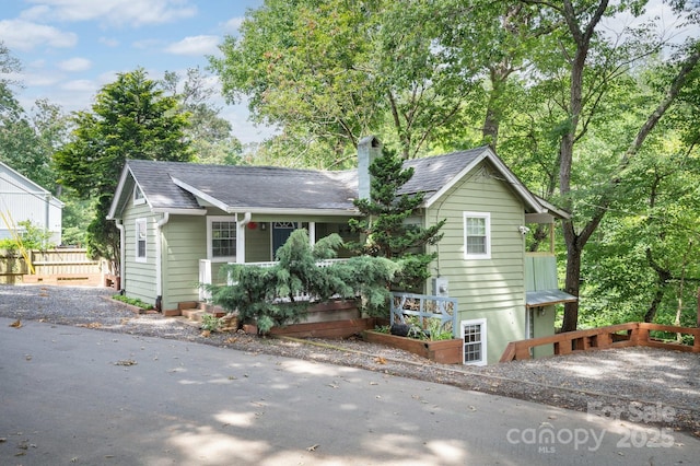 5 Arbutus Rd, Asheville, NC 28805 - view of front of home with a chimney, roof with shingles, and a porch
