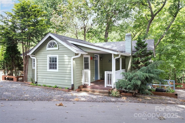 5 Arbutus Rd, Asheville, NC 28805 - view of front of house featuring a chimney, view of scattered trees, and a shingled roof