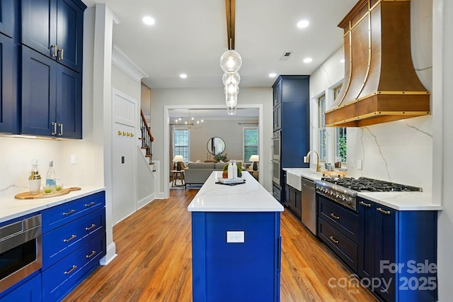 7903 Tottenham Ct, Waxhaw, NC 28173 - kitchen featuring custom exhaust hood, stainless steel appliances, light wood-type flooring, a center island, and recessed lighting