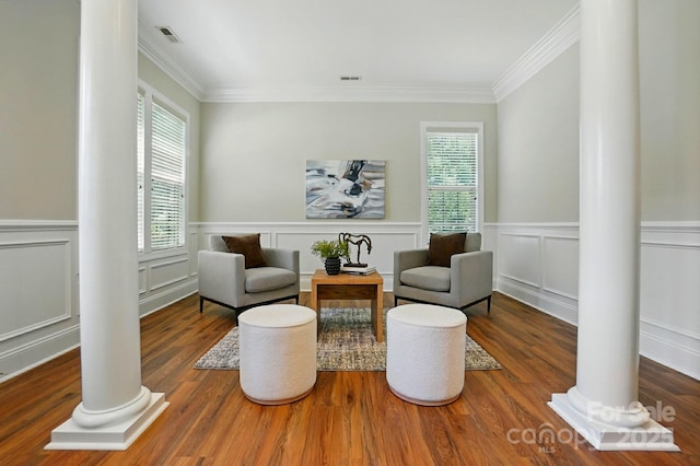 7903 Tottenham Ct, Waxhaw, NC 28173 - living area with decorative columns, ornamental molding, wood finished floors, and a wainscoted wall