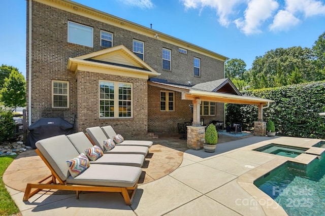7903 Tottenham Ct, Waxhaw, NC 28173 - back of house with a patio area, an in-ground hot tub, brick siding, an outdoor living space, and an outdoor pool