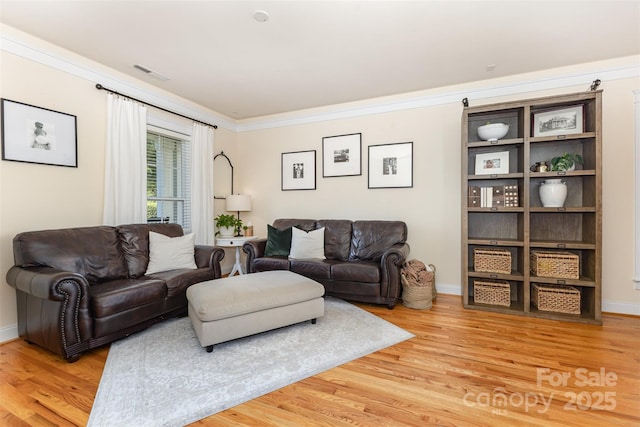 7344 Gilead Rd, Huntersville, NC 28078 - living room with light wood finished floors and ornamental molding
