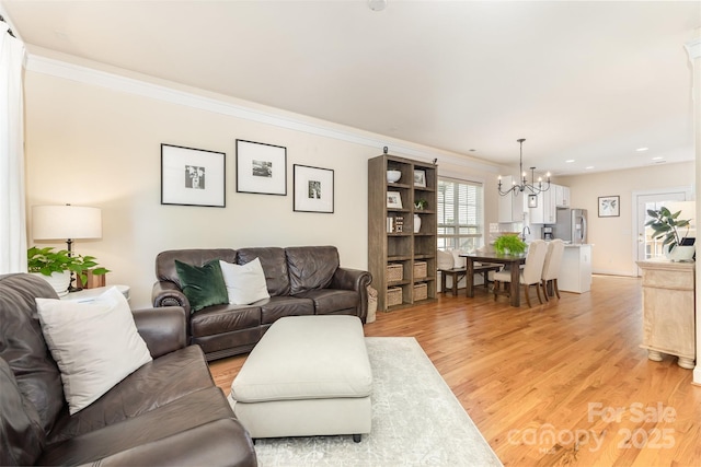 7344 Gilead Rd, Huntersville, NC 28078 - living room featuring a chandelier, ornamental molding, light wood-style flooring, and recessed lighting