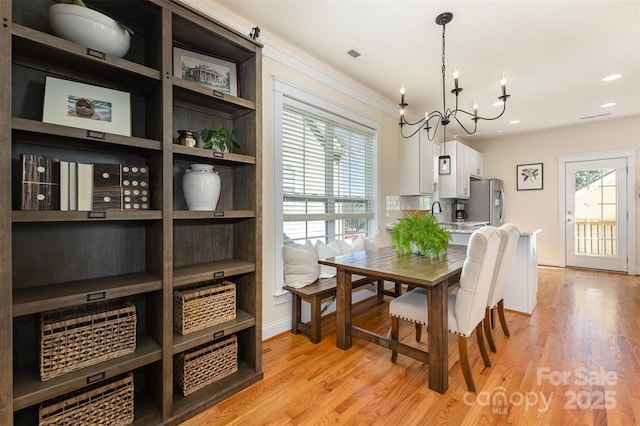 7344 Gilead Rd, Huntersville, NC 28078 - dining space featuring a chandelier, light wood-style floors, and recessed lighting