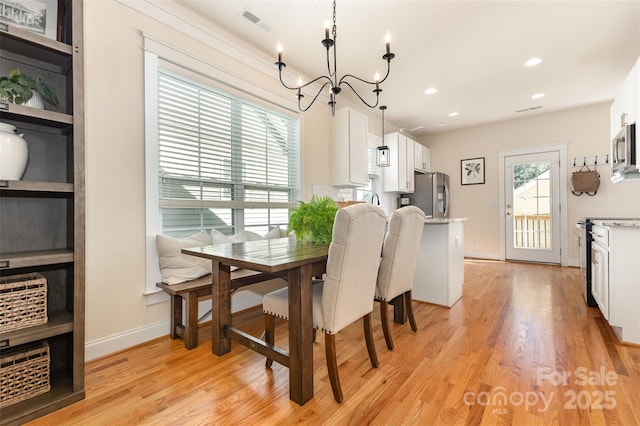 7344 Gilead Rd, Huntersville, NC 28078 - dining space with a chandelier, light wood finished floors, and recessed lighting